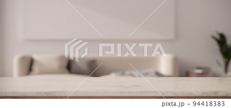 Natural white marble tabletop with copy space in front of blurred minimal living room background 94418383