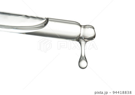 Pipette with a drop of cosmetic product on a white background. 94418838