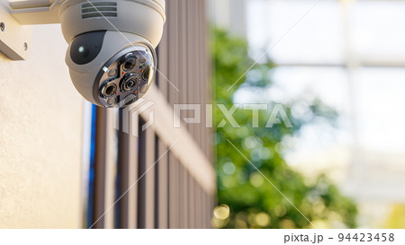 CCTV camera installed on wall of the building or office. Scan the area for surveillance purposes. 94423458