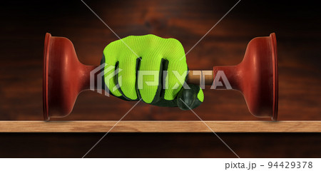 Gloved Hand Holding a Red Rubber Plunger with Wooden Handle Gloved Hand Holding a Red Rubber Plunger with Wooden Handle 94429378
