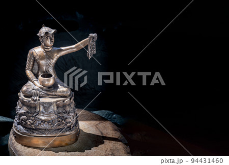 Bronze figurine of Phra upagupta or Phra bua khem statue on dark background with Natural Light. Bronze figurine of Phra upagupta or Phra bua khem statue on dark background with Natural Light. 94431460