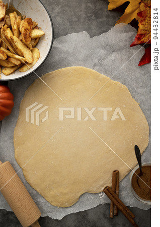 Apple pie. Cooking autumn strudel with fresh apples and cinnamon. Dark background. 94432814