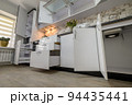 Renovated Interior for modern trendy white kitchen with doors open 94435441