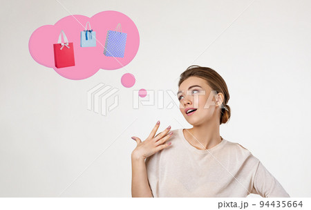 beautiful young woman thinks about shopping beautiful young woman thinks about shopping 94435664