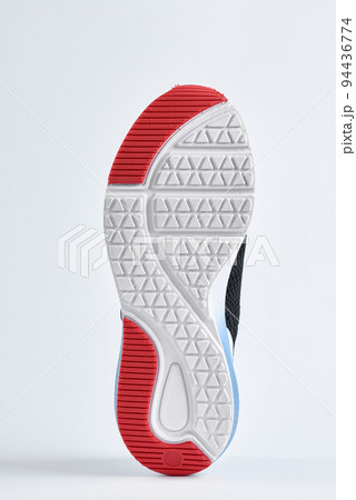 Trendy fashionable sneakers with sole on white background. Stylish sports casual shoes. Creative minimalistic layout with footwear 94436774