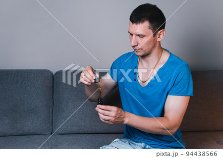 Adult man using and holding medical cannabis oil. CBD Adult man using and holding medical cannabis oil. CBD 94438566