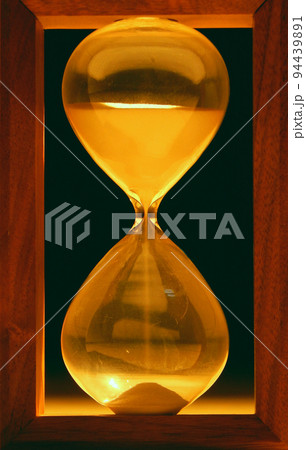 Sand falls inside hour glass  94439891