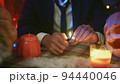 Close-up of a table with candles and a garland, Halloween atmosphere, creepy 94440046