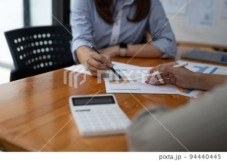 Close up business colleagues discussing financial documents. 94440445