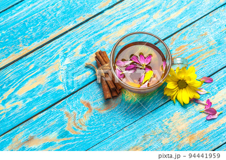 Cup with aromatic hot cinnamon tea on wooden table Cup with aromatic hot cinnamon tea on wooden table 94441959
