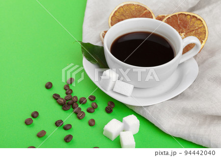 Cup of coffee on green background. 94442040