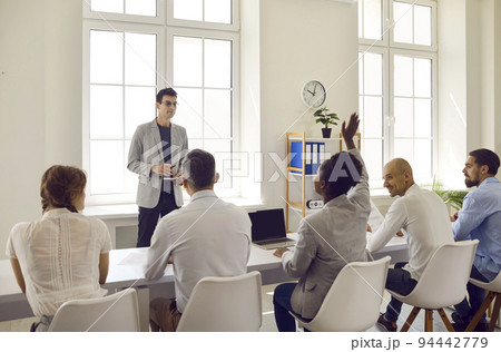Team of people sitting in the office and having class with a professional business coach 94442779