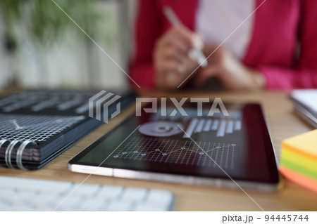 Female leader with business charts on tablet holding business intelligence data. Female leader with business charts on tablet holding business intelligence data. 94445744
