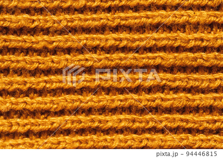 Background of yellow knitted woolen thread close-up 94446815
