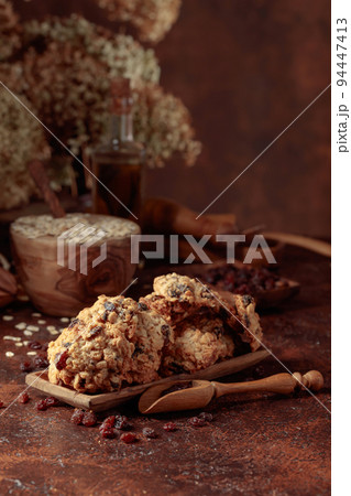 Oatmeal raisin cookies on a brown table. Oatmeal raisin cookies on a brown table. 94447413