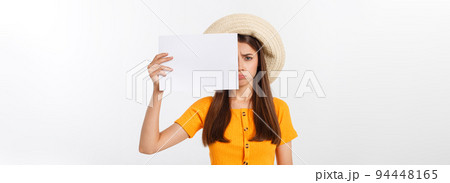Young caucasian woman holding blank paper sheet over isolated background scared in shock with a surprise face, afraid and excited. Young caucasian woman holding blank paper sheet over isolated background scared in shock with a surprise face, afraid and excited. 94448165