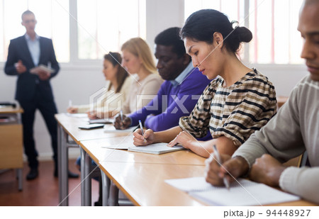 Woman in group of students in university audience Woman in group of students in university audience 94448927