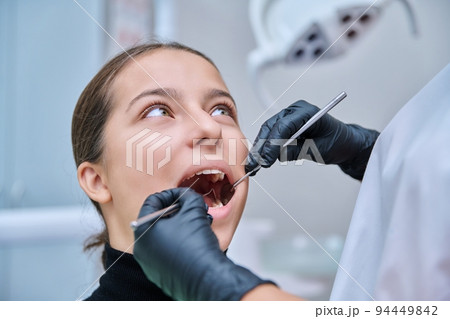 Young teenage female at dental checkup in clinic. Young teenage female at dental checkup in clinic. 94449842