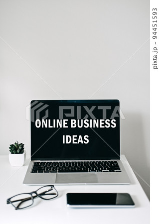 Online business ideas. Starting Small Business Online. Modern workspace with Online business text on screen laptop, cell phone, pencil, on white work table. 94451593
