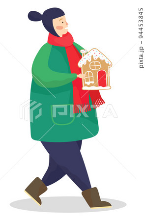 Kid Carrying Gingerbread Cookie in Form of House Kid Carrying Gingerbread Cookie in Form of House 94453845
