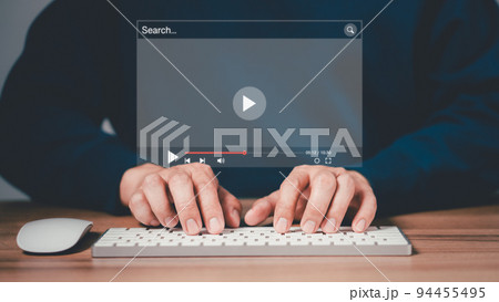 Man using mouse and keyboard for streaming online on virtual screen, searching video on internet, live football, show or tutorial, watching the movies, content online. Man using mouse and keyboard for streaming online on virtual screen, searching video on internet, live football, show or tutorial, watching the movies, content online. 94455495