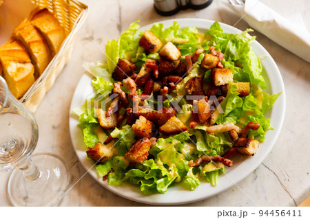Lettuce, crouton, lardon salad on plate 94456411