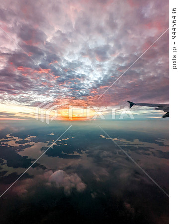 early morning sunrise from an airplane 94456436