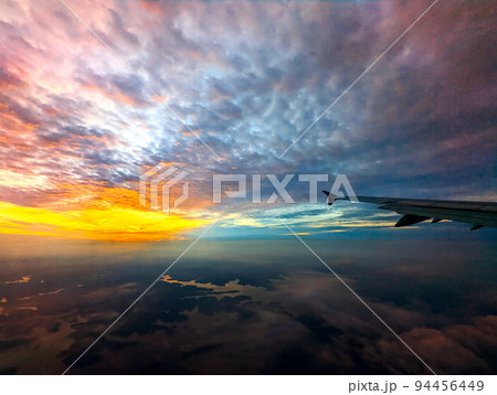 early morning sunrise from an airplane 94456449