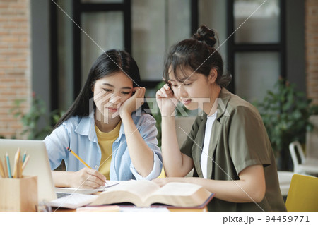 Young asian students campus helps friend catching up and learning. Young asian students campus helps friend catching up and learning. 94459771