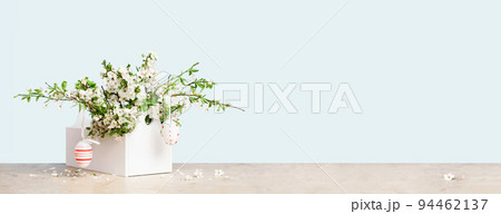 Spring blooming tree branches in a vase on tender green blue Spring blooming tree branches in a vase on tender green blue 94462137