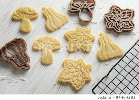 Baking cookies in the form of pumpkin and leaves Baking cookies in the form of pumpkin and leaves 94464293