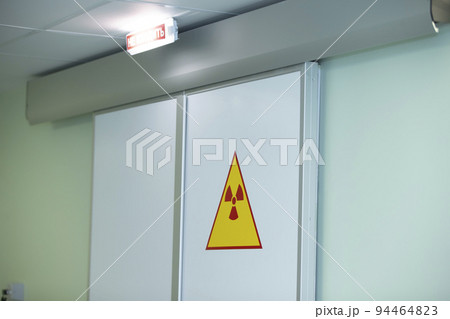 Radiation sign on the doors in the hospital. High radiation warning. 94464823