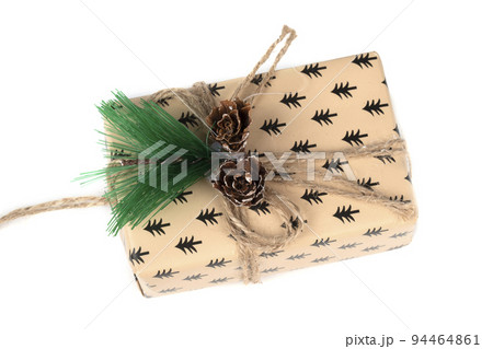 Christmas gift box decorated with a fir branch on a white background. 94464861