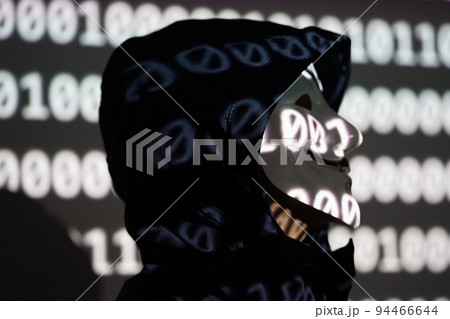 Brussels, Belgium - September 16, 2022: Hooded identity theft wearing an Anonymous Guy Fawkes mask Brussels, Belgium - September 16, 2022: Hooded identity theft wearing an Anonymous Guy Fawkes mask 94466644