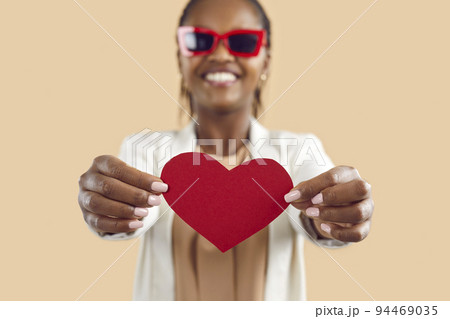 Happy black woman show red paper heart 94469035