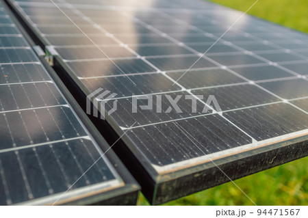 Close up on female hand touching stroking photovoltaic solar panels in sunny day, renewable clean energy power concept 94471567