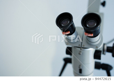 Close-up of a dental microscope on a white background Close-up of a dental microscope on a white background 94472615