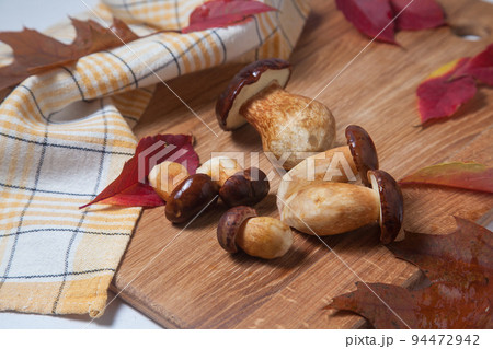 Several Imleria Badia or Boletus badius mushrooms commonly known as the bay bolete on wooden cutting board.. Several Imleria Badia or Boletus badius mushrooms commonly known as the bay bolete on wooden cutting board.. 94472942