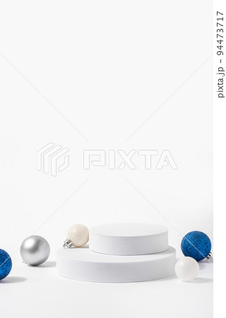 Cosmetic background for Christmas and winter holiday. White podium, christmas balls and snow on white background. 94473717