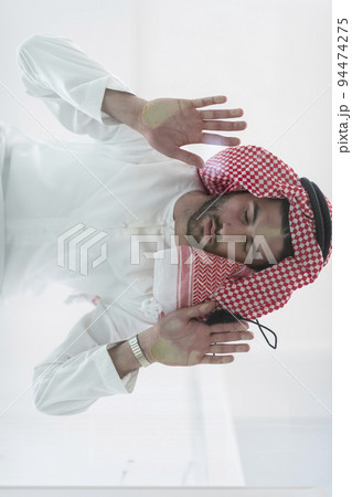 Muslim man doing sujud or sajdah on the glass floor 94474275