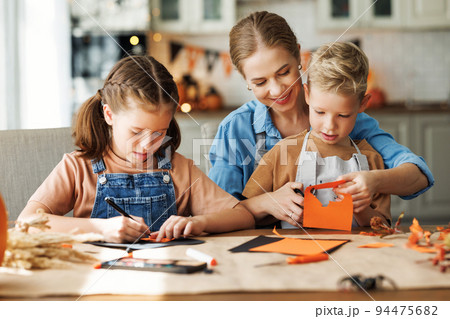 Young family mother and children preparing decorations for Halloween 94475682