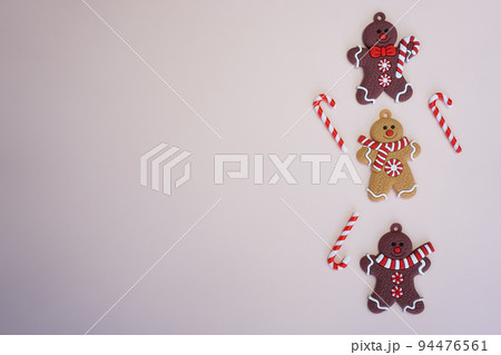 On a light background there are Christmas men, sweet canes and a place for text On a light background there are Christmas men, sweet canes and a place for text 94476561