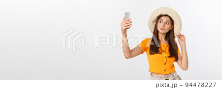 Young Caucasian woman enjoying the selfie with herself isolated on white background summer travel concept. Young Caucasian woman enjoying the selfie with herself isolated on white background summer travel concept. 94478227