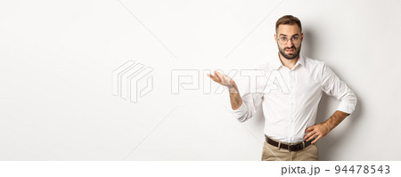 Confused office worker shrugging, cant understand something, standing over white background 94478543