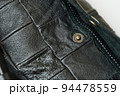 Metal knob and zipper on leather bag 94478559