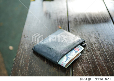 left wallet on a bench in the park left wallet on a bench in the park 94481021