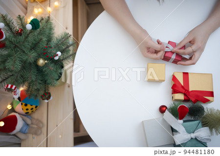 flat lay woman hand decorate christmas tree and new year gift box flat lay woman hand decorate christmas tree and new year gift box 94481180