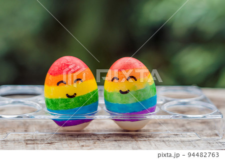 Two eggs are colored in the colors of the rainbow as a flag of gays and lesbians as well as Easter eggs. Homosexual concept Two eggs are colored in the colors of the rainbow as a flag of gays and lesbians as well as Easter eggs. Homosexual concept 94482763