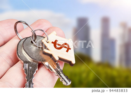 The keys to the new apartment in the hand of a man against the backdrop of urban development The keys to the new apartment in the hand of a man against the backdrop of urban development 94483833