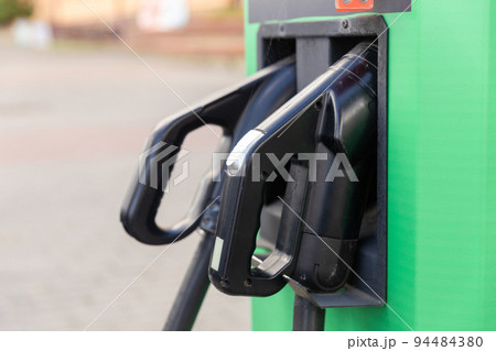 Charging station for electric vehicles with two types of cables for connection. Charging station for electric vehicles with two types of cables for connection. 94484380